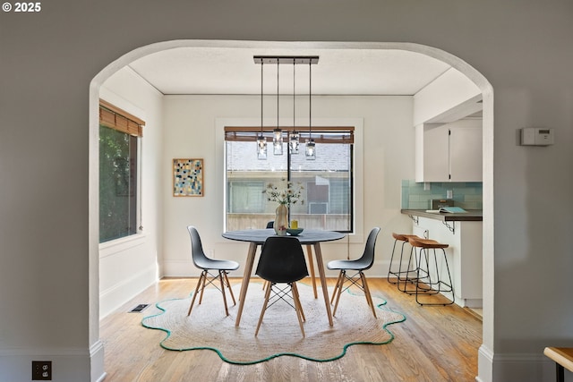 5655 SW Lombard Ave, Beaverton, OR 97005 - dining space featuring arched walkways, wood finished floors, and a chandelier