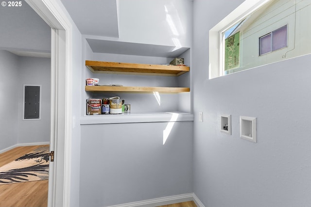 interior space featuring laundry area, hookup for a washing machine, electric panel, and light wood-style floors