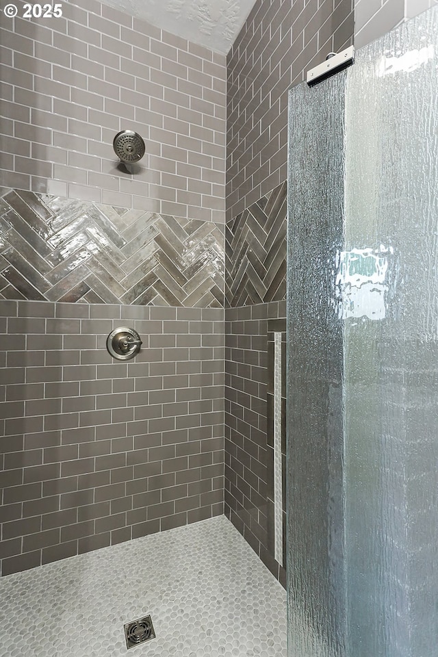 bathroom with a tile shower