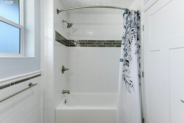 full bath featuring shower / bathtub combination with curtain, a wainscoted wall, and tile walls