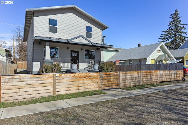 view of front of home featuring a fenced front yard and covered porch