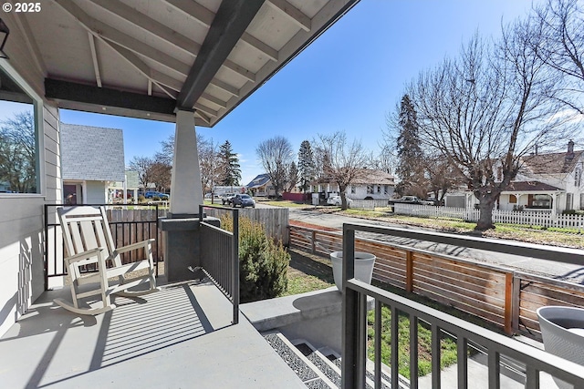 balcony with covered porch and a residential view