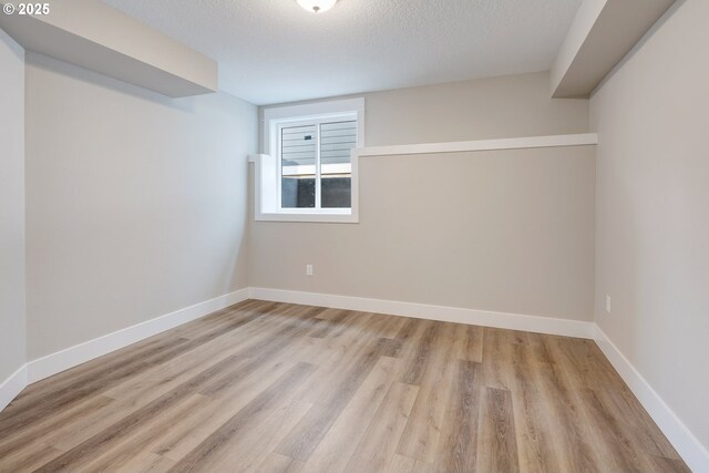 414 Hedin Ter, Gaston, OR 97119 - empty room featuring wood finished floors, baseboards, and a textured ceiling