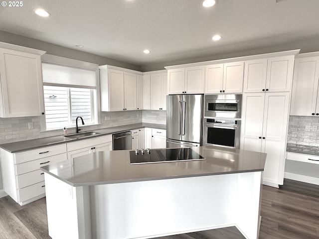 414 Hedin Ter, Gaston, OR 97119 - kitchen featuring appliances with stainless steel finishes, a sink, dark wood-style floors, white cabinets, and recessed lighting