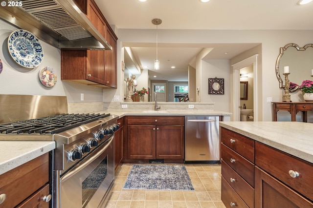 8867 SE 13th Ave, Portland, OR 97202 - kitchen featuring stainless steel appliances, range hood, recessed lighting, decorative light fixtures, and light stone countertops