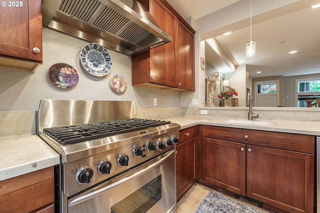 8867 SE 13th Ave, Portland, OR 97202 - kitchen with high end stove, premium range hood, recessed lighting, decorative light fixtures, and light stone counters