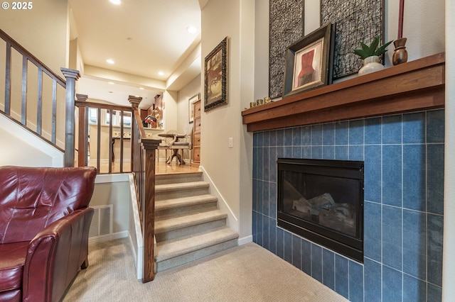 8867 SE 13th Ave, Portland, OR 97202 - stairs featuring carpet floors, recessed lighting, and a tile fireplace