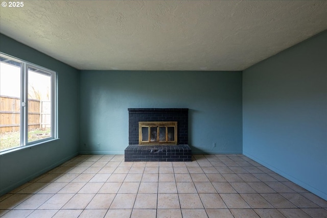 unfurnished living room with light tile patterned floors, a textured ceiling, and a brick fireplace