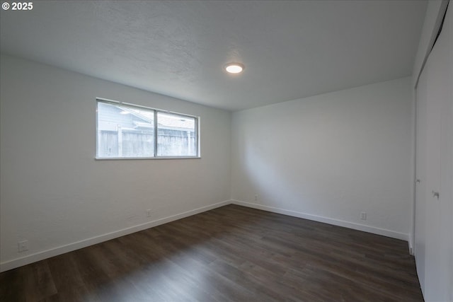 unfurnished room featuring dark hardwood / wood-style floors