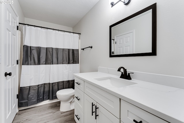 2977 Dry Creek Rd, Eugene, OR 97404 - full bathroom featuring vanity, toilet, wood finished floors, and a shower with shower curtain