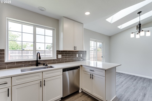 2977 Dry Creek Rd, Eugene, OR 97404 - kitchen featuring dishwasher, a sink, a skylight, vaulted ceiling, and tasteful backsplash