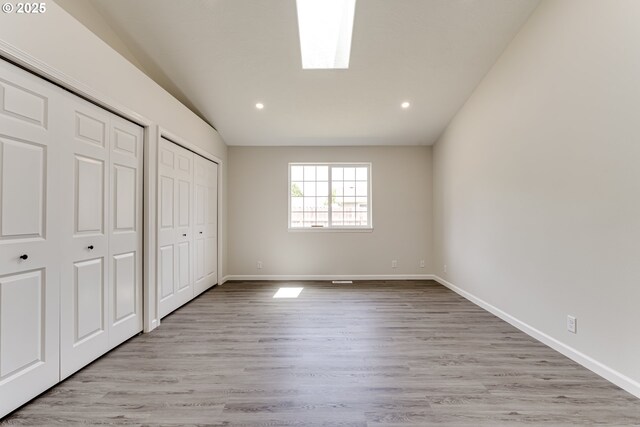 2977 Dry Creek Rd, Eugene, OR 97404 - unfurnished bedroom featuring two closets, light wood-type flooring, baseboards, recessed lighting, and lofted ceiling