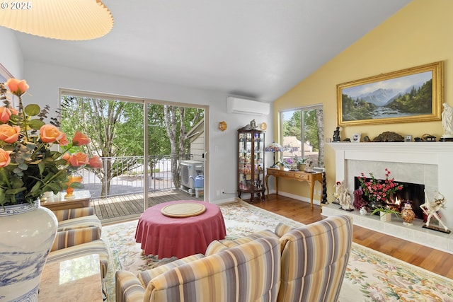 10137 SW Trapper Ter, Beaverton, OR 97008 - living room featuring a wall mounted AC, a fireplace, lofted ceiling, plenty of natural light, and wood finished floors