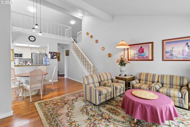 10137 SW Trapper Ter, Beaverton, OR 97008 - living area featuring wood finished floors, stairs, and high vaulted ceiling