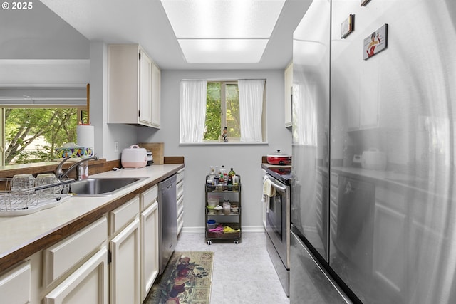 10137 SW Trapper Ter, Beaverton, OR 97008 - kitchen with stainless steel appliances, healthy amount of natural light, and light countertops