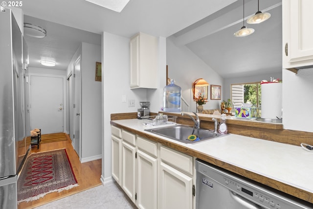 10137 SW Trapper Ter, Beaverton, OR 97008 - kitchen with appliances with stainless steel finishes, white cabinetry, pendant lighting, light countertops, and vaulted ceiling