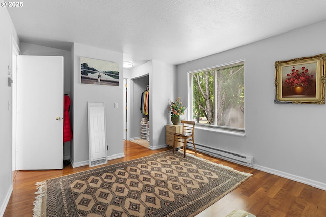 10137 SW Trapper Ter, Beaverton, OR 97008 - entryway featuring baseboard heating, wood finished floors, and a textured ceiling