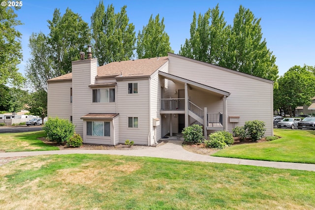 10137 SW Trapper Ter, Beaverton, OR 97008 - view of front of house with a front yard, stairs, a chimney, and a shingled roof