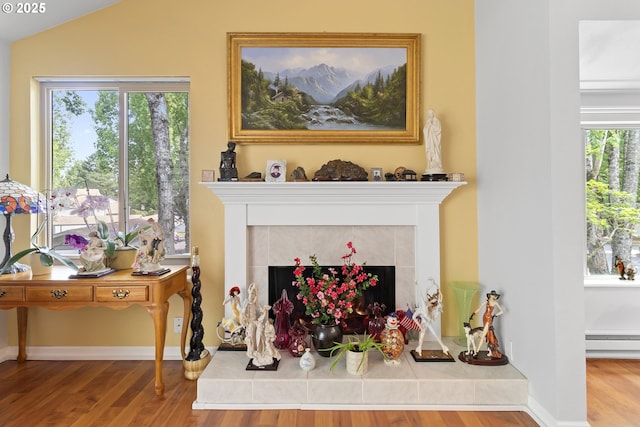 10137 SW Trapper Ter, Beaverton, OR 97008 - living room featuring a fireplace, wood finished floors, and a baseboard radiator