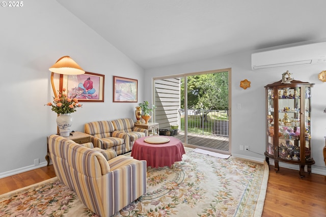 10137 SW Trapper Ter, Beaverton, OR 97008 - living room with a wall unit AC, wood finished floors, and vaulted ceiling