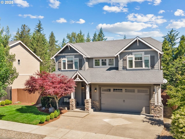 5703 SE 10th St, Gresham, OR 97080 - craftsman-style house with concrete driveway, stone siding, a garage, and roof with shingles