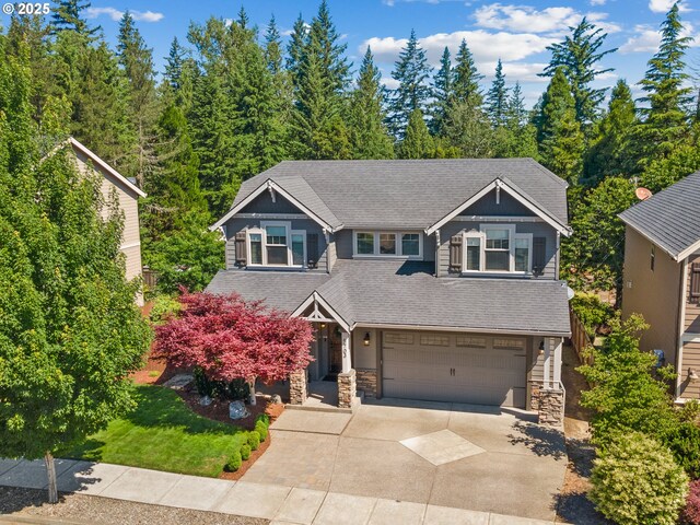 5703 SE 10th St, Gresham, OR 97080 - craftsman-style house featuring stone siding, driveway, an attached garage, and a shingled roof