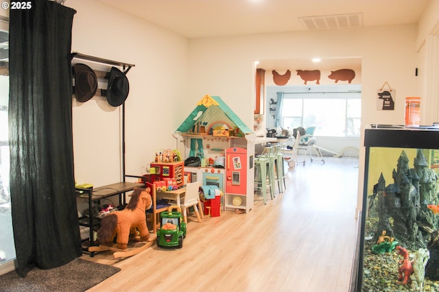 game room with visible vents and wood finished floors