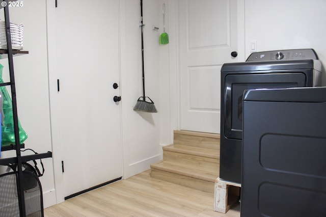 washroom featuring wood finished floors, washer / clothes dryer, and laundry area