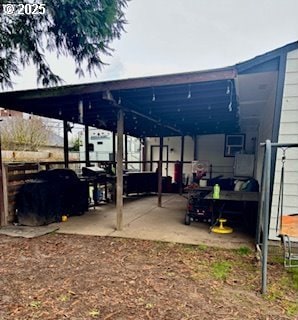 view of patio / terrace with fence and an attached carport