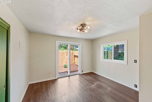 1565 California Ave, Coos Bay, OR 97420 - empty room with wood finished floors, healthy amount of natural light, and a textured ceiling