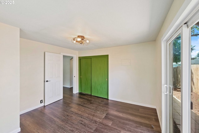 1565 California Ave, Coos Bay, OR 97420 - unfurnished bedroom featuring wood finished floors, access to exterior, and a closet