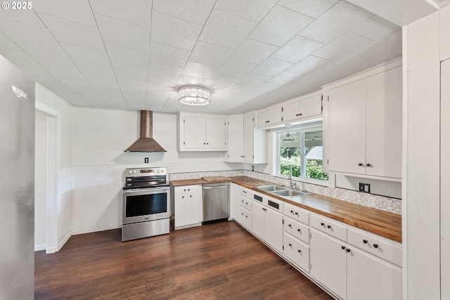 1565 California Ave, Coos Bay, OR 97420 - kitchen with appliances with stainless steel finishes, wall chimney range hood, dark wood finished floors, and white cabinets