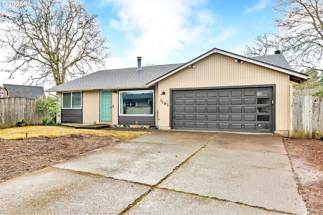 single story home featuring a garage, a shingled roof, fence, and concrete driveway