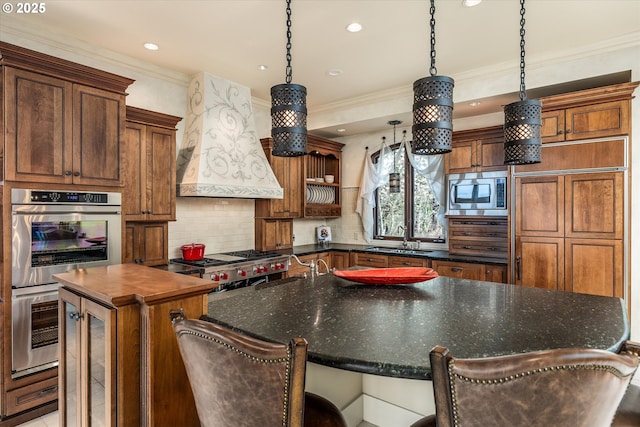 325 Rio Vista Dr, White Salmon, WA 98672 - kitchen with custom exhaust hood, a large island, a sink, appliances with stainless steel finishes, and backsplash