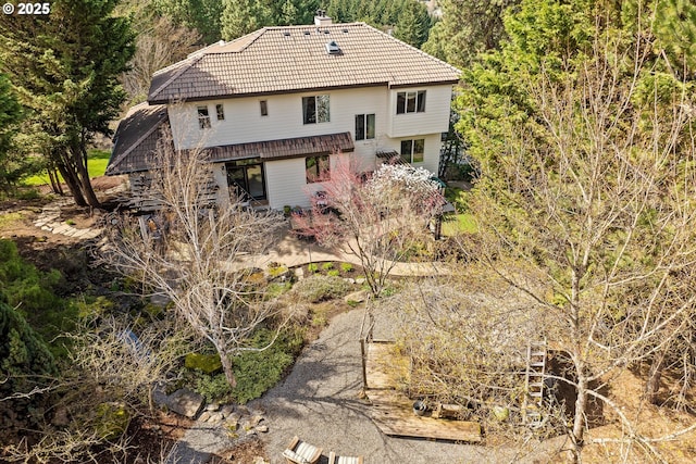 325 Rio Vista Dr, White Salmon, WA 98672 - rear view of house with a forest view, a chimney, and a tile roof