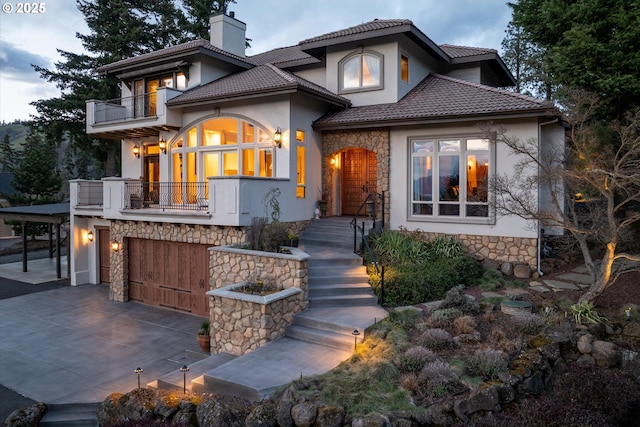 325 Rio Vista Dr, White Salmon, WA 98672 - view of front facade with stucco siding, stone siding, a tile roof, a balcony, and a chimney