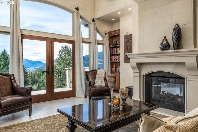 325 Rio Vista Dr, White Salmon, WA 98672 - living area featuring french doors, a glass covered fireplace, plenty of natural light, and tile patterned flooring