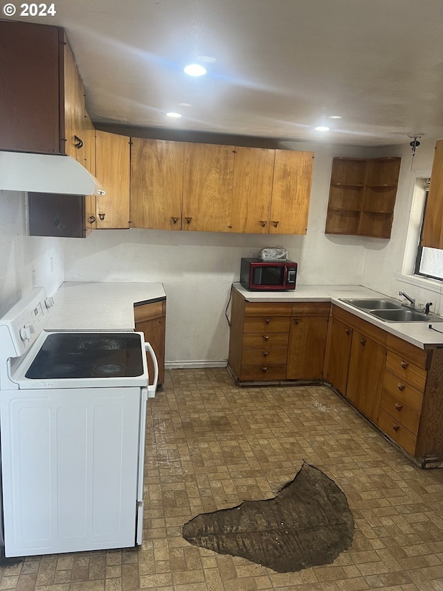 kitchen with under cabinet range hood, white electric stove, brown cabinetry, and a sink