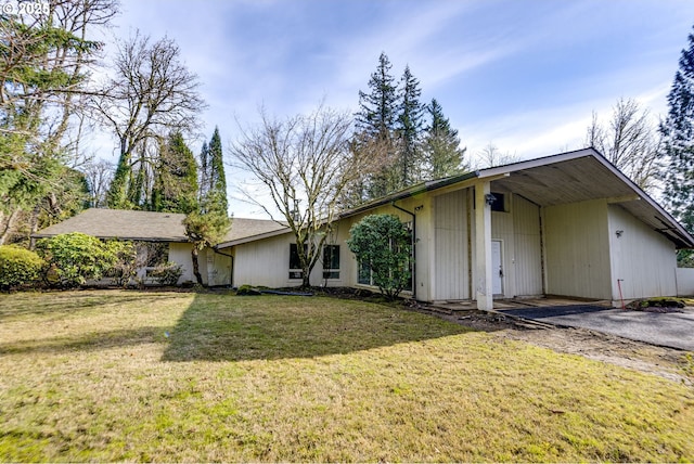 ranch-style home featuring a front yard and a carport