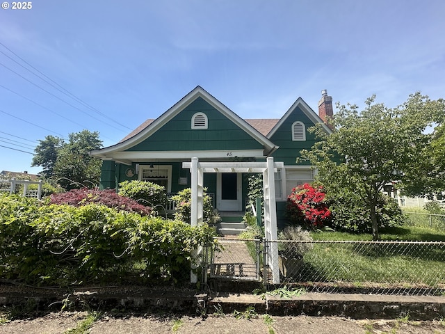 45 S 12th St, Cottage Grove, OR 97424 - view of front of house featuring a fenced front yard, covered porch, and a chimney