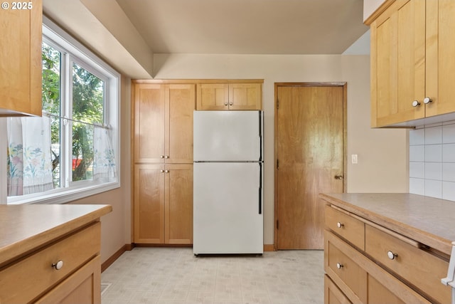 6395 SW Wilson Ave, Beaverton, OR 97008 - kitchen with freestanding refrigerator, light brown cabinets, light floors, and decorative backsplash