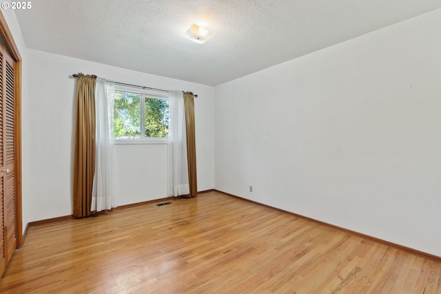 6395 SW Wilson Ave, Beaverton, OR 97008 - empty room with light wood finished floors and a textured ceiling
