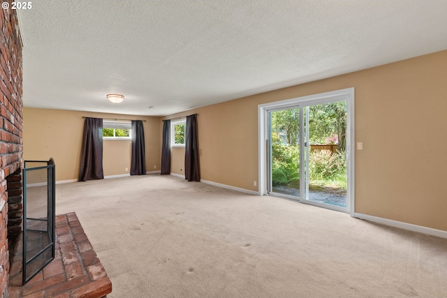 6395 SW Wilson Ave, Beaverton, OR 97008 - unfurnished living room featuring a fireplace, light carpet, and a textured ceiling
