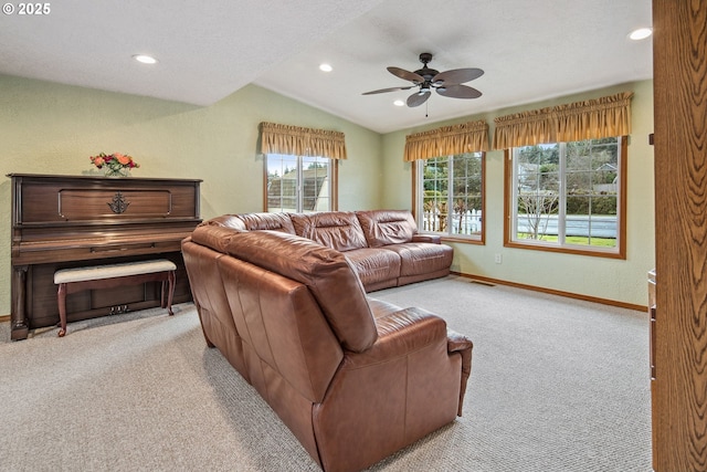 living room featuring lofted ceiling, a textured ceiling, light colored carpet, and ceiling fan