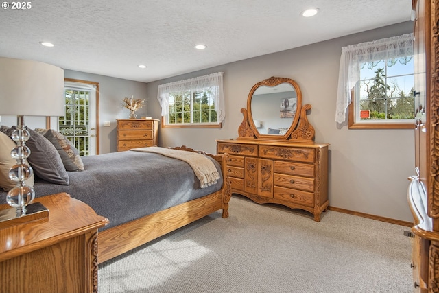 carpeted bedroom with a textured ceiling and access to outside