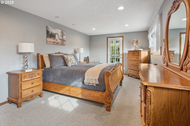 bedroom featuring light carpet, access to exterior, and a textured ceiling