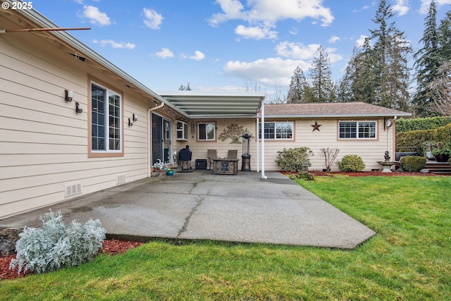 rear view of property with a patio area and a lawn