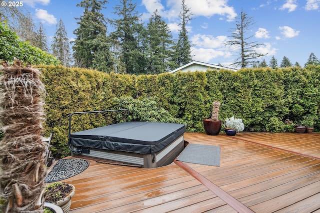 wooden deck featuring a covered hot tub