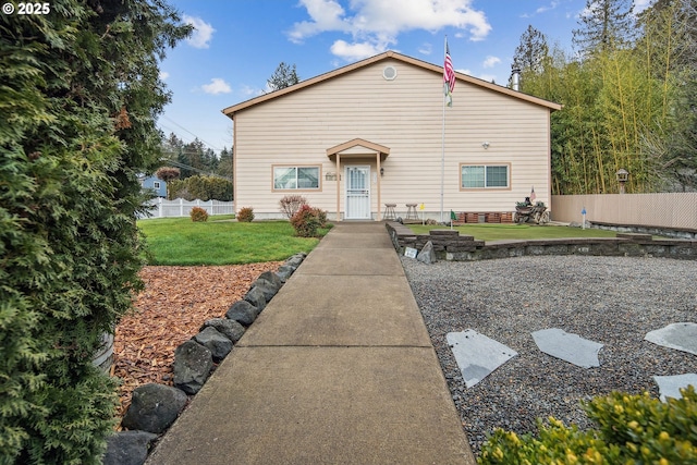 view of front of home with a patio and a front lawn