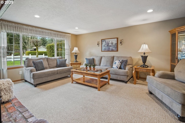 living room featuring light colored carpet and a textured ceiling